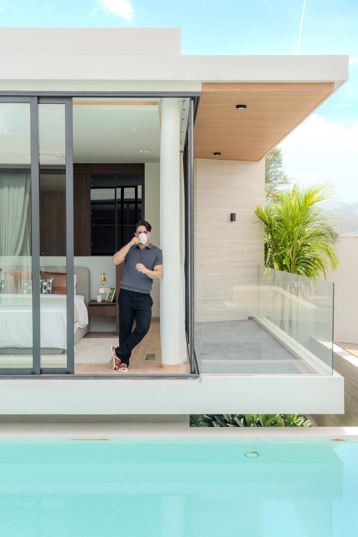 Villa terrace and swimming pool surrounded by tropical planting