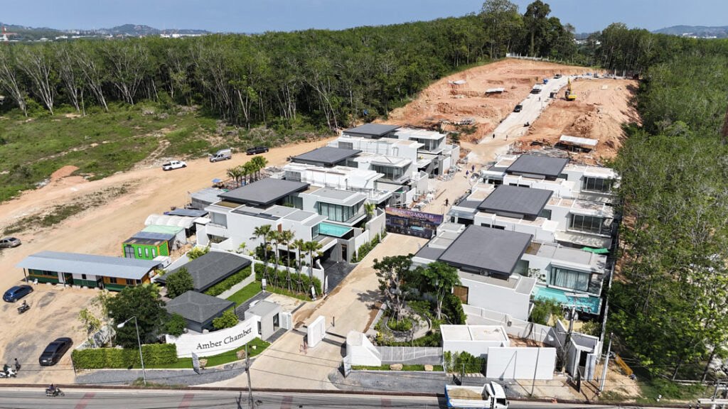 Aerial view of the Amber Chamber construction site with completed villa shells